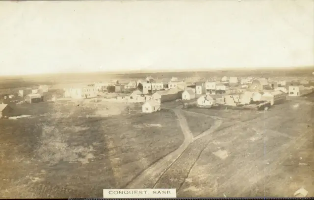 Aerial view of Conquest from a height, with dirt roads leading into town